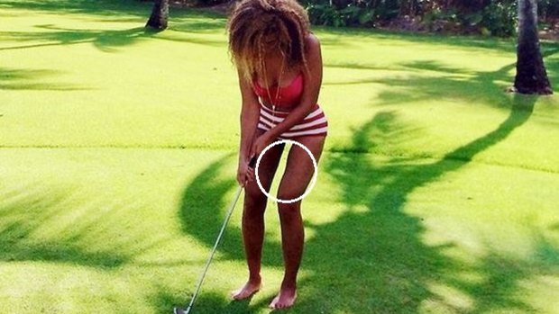 While playing golf in a red and white striped bikini, again Beyonce's thighs appeared altered.