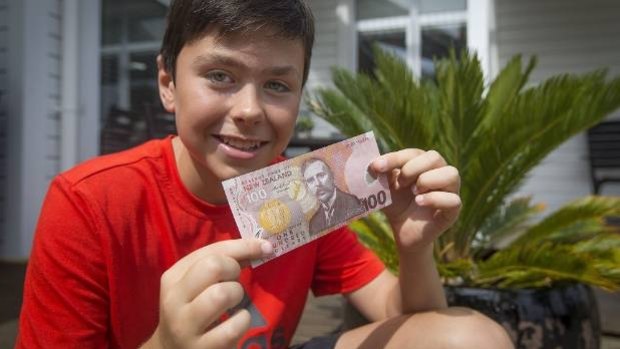 Sam McIntosh, 12, with the $NZD100 reward he got after handing in the wallet of an Australian man he found containing $NZD1400.