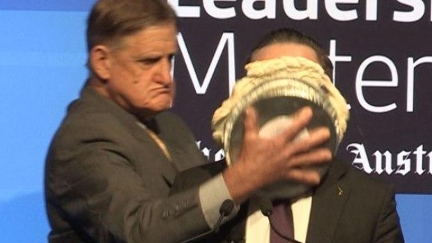 Alan Joyce hit with a pie during an event in Perth on Tuesday.