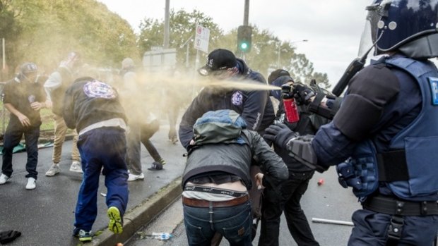 Protesters and police clash at the Coburg rally on Saturday. 