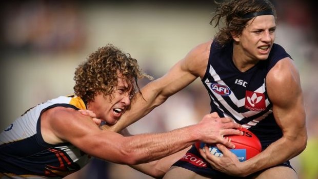 Matt Priddis, seen here tackling Nathan Fyfe of the Dockers, will also be back to strengthen the West Coast line-up.
