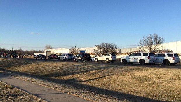 Police vehicles line the road after reports of a shooting at an industrial site in Hesston.