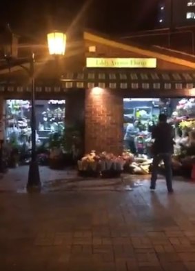 A screenshot from a video posted on social media shows the moment the man emerged from the florist. 