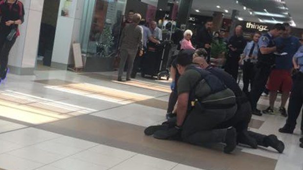 Police arrest a man in front of shoppers in Rockingham.