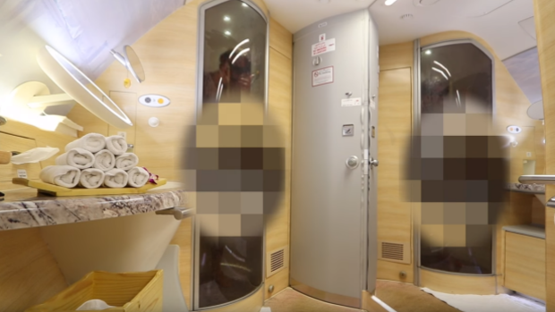 Showering in Emirates First Class bathroom.