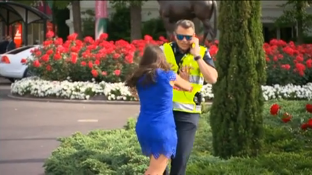 Sarah Finn pushes Acting Superintendent Steven Cooper into a bush at Flemington on Melbourne Cup Day.