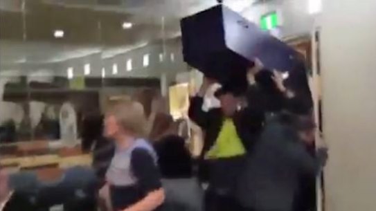 Far-right protesters disrupt Moreland's council meeting brandishing a fake coffin.