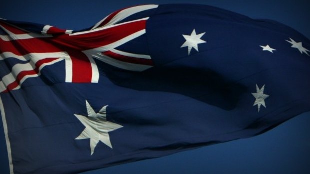 A man was charged after allegedly setting a flag on fire in Cairns.