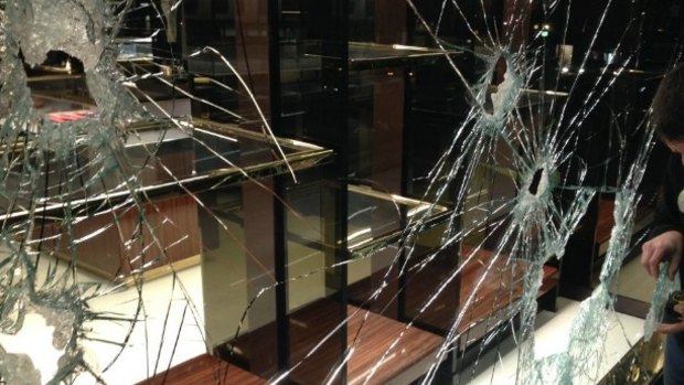 The smashed windows at the Gucci store on Collins Street.