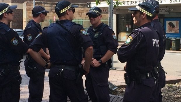 Two charged: Police outside Parramatta Local Court.