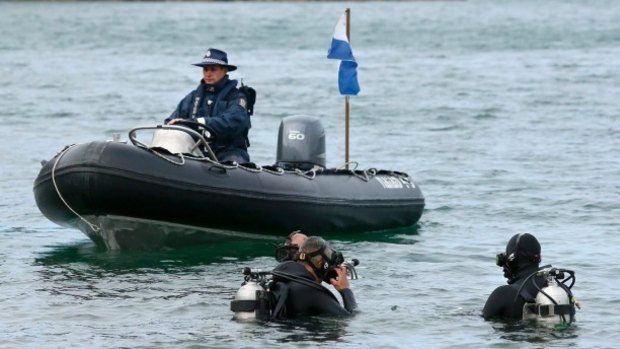 Police divers search the waters around Miramar Pensinsula in the hunt for a disguise they believe Michael Preston may have worn.