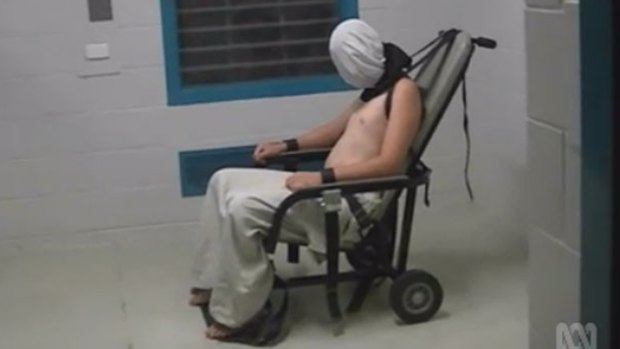 An image from the Four Corners program showing a teenage boy strapped to a mechanical chair in an Alice Springs prison.