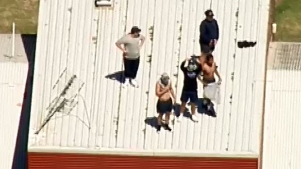 Youths climb onto the roof of the Malmsbury centre during the most recent riot. 
