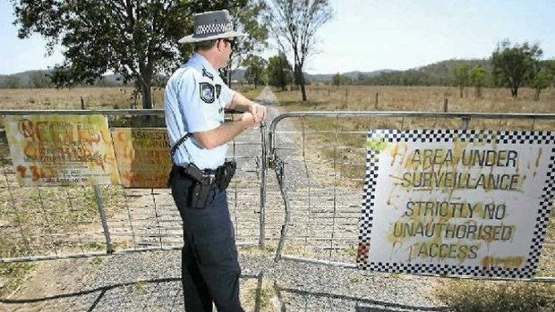 Officer-in-charge of Gracemere Police Station Sergeant Ben Holdcroft at the locked gates of the abandoned St Joseph's Orphanage at Neerkol in 2012.
