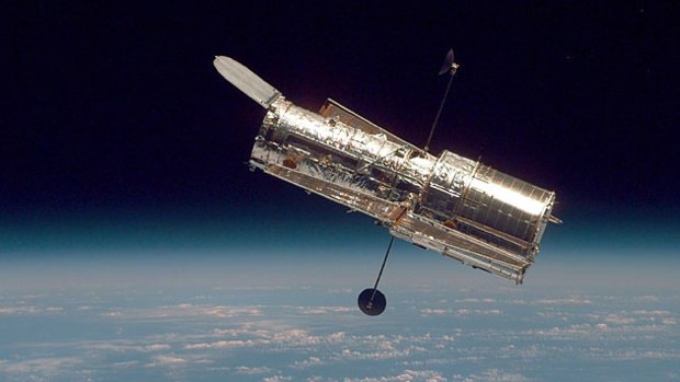 The Hubble Space Telescope hovers at the boundary of Earth and space in 1997.