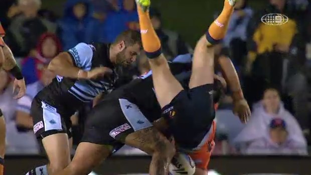 Newcastle hooker Adam Clydsdale is upended by Sharks prop Andrew Fifita.
