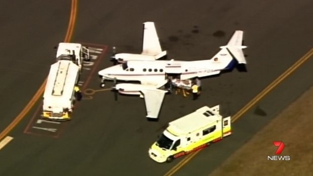 A burns victim arrives in Brisbane for treatment on Wednesday morning.