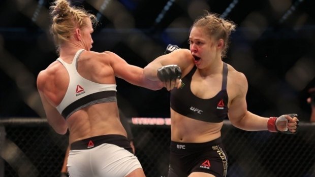 Upset: Hot favourite Ronda Rousey (in black) was easily defeated by Holly Holm.