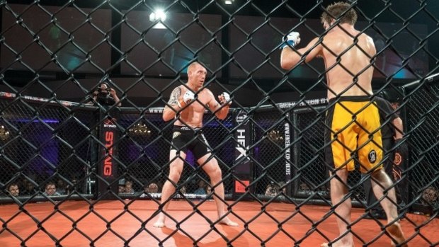Inaugural bout:  Ryan Barry (L) fights Troy Resic during the Hex Fight Series, Victoria's first legal MMA cage fight, in March, 2015.