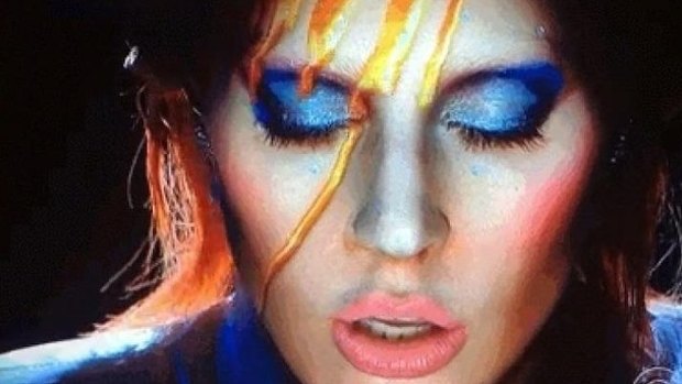 Light fantastic ... Lady Gaga began her Bowie tribute with futuristic projections on her face.