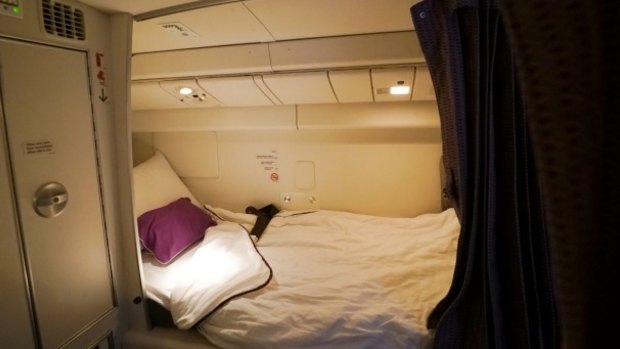Flight attendants sleep in the area above economy class that has eight single beds with sheets, blankets and pillows.