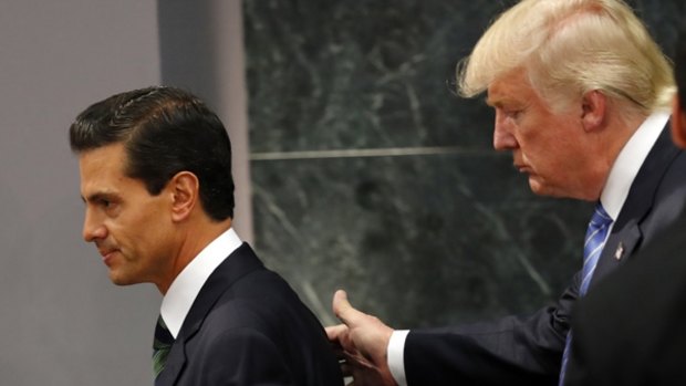 Republican presidential nominee Donald Trump walks with Mexican President Enrique Pena Nieto.