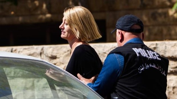 60 Minutes reporter Tara Brown escorted from court in Beirut on Monday.