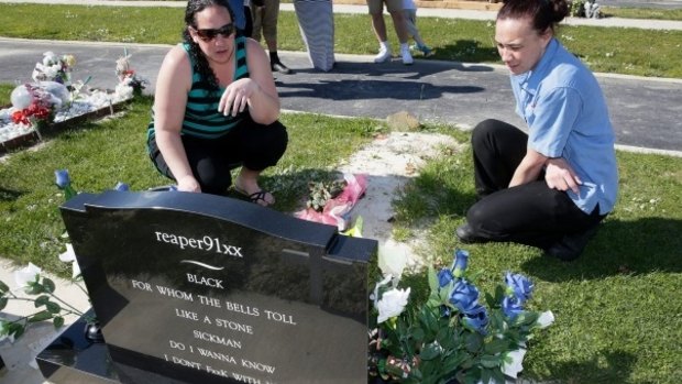 Vincent Drummond-Paulo's aunt, Michelle Rongokea, left, and mother, Jeanna Scott,  at his grave.