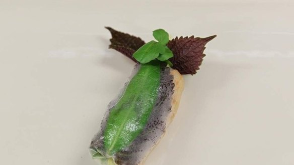 16. A finished rice paper roll, with garnish. 
