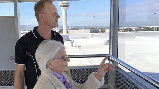 Pauline Heal is giddy with joy seeing a plane land at Perth Airport with former Eagle Karl Langdon.