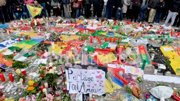 People gather at Place de la Bourse in Brussels in honour of the victims of Tuesdays' terror attacks.