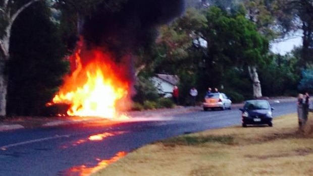 A car on fire on Dryandra St in O'Connor after being struck by lightning.