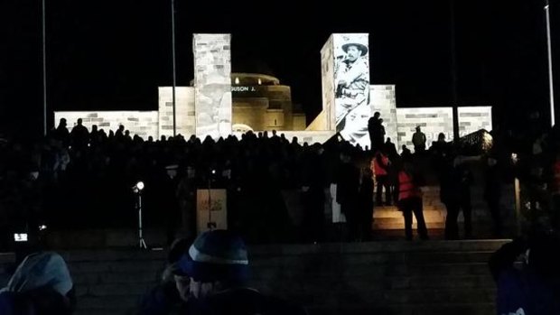 Tens of thousands stand in silence at the Dawn Service in Canberra