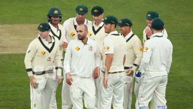 Main man: The team celebrates after Nathan Lyon claimed the wicket of Marlon Samuels. 