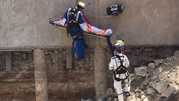 Emergency services have freed a man who was stuck down a 15-metre pit on a Cronulla building site.
