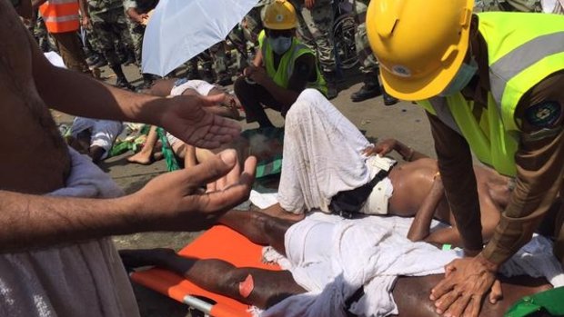 An emergency worker performs CPR on a pilgrim at Mecca.