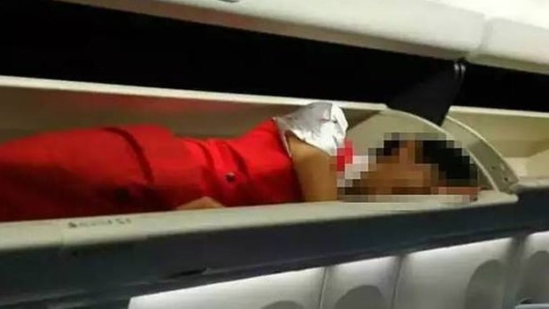 Chinese female flight attendants forced into overhead bins as part of hazing ritual at Kunming Airlines.