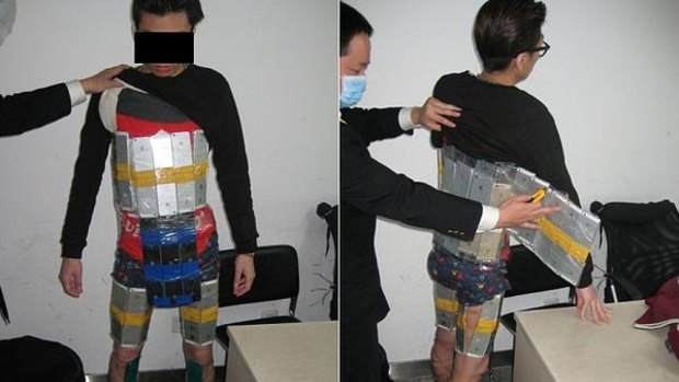 'Apple Man' ... this man was allegedly caught trying to smuggle 94 iPhones into mainland China from Hong Kong. Authorities were suspicious of the way he walked, according to reports.