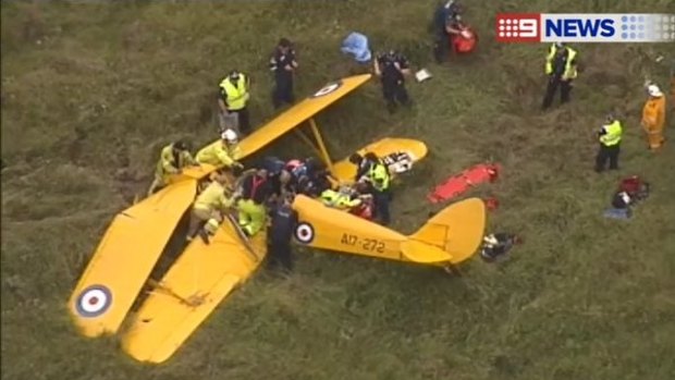 Emergency services work to free a person trapped in the wreckage of a light plane crash on the Gold Coast.