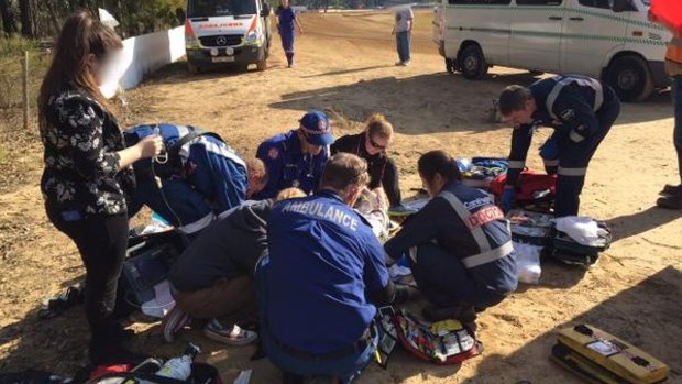 Paramedics and the CareFlight medical crew treat a patient at Nepean Raceway.