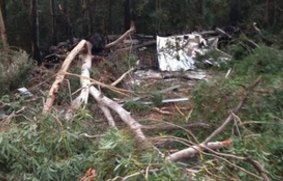 The wreck of the semi-trailer, which crashed over the edge of Barrengarry Mountain near Kangaroo Valley and caught on fire early on Friday.