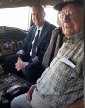 Melvin Rector, right, was invited by the pilot of the American Arlines flight to visit the cockpit on the way to Britain.