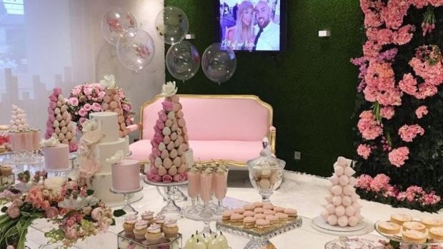 The lavish spread complete with a three-tier cake and towers of pink and white macaroons and cake pops.