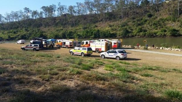 Emergency crews search for a man missing in the Brisbane River at Karana Downs on Sunday.