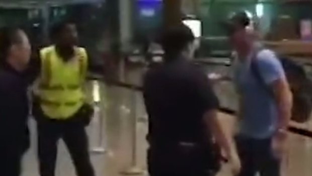 Police and Perth man Jason Peter Darragh tussle at Changi Airport in Singapore.