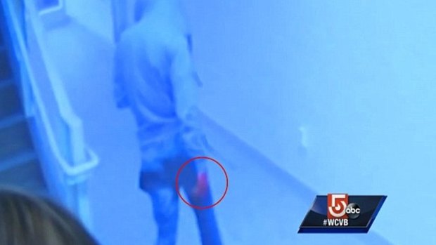 A male police allege is Philip Chism leaves the bathroom, his right hand visibly red.