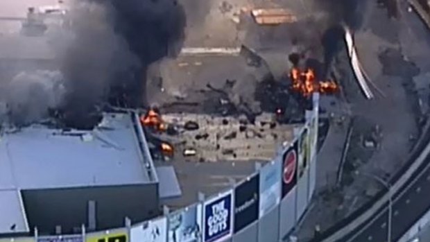 The fiery aftermath of the plane crash at DFO Essendon. 