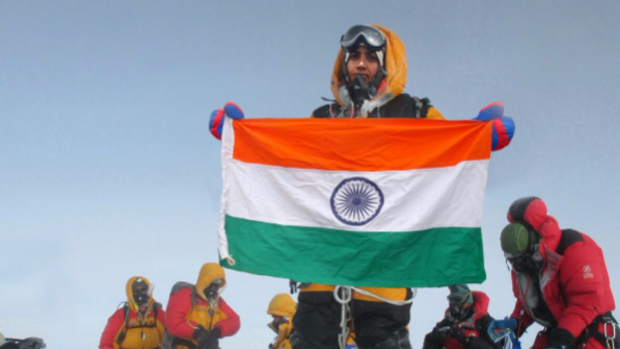 Tarkeshwari Rathod, with flag, at what the couple said was the Everest summit.