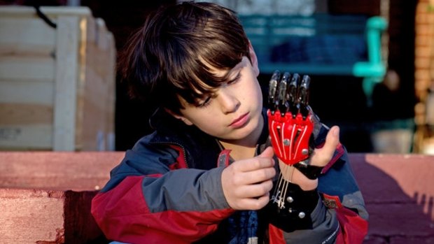 Ethan Brown, 8, was born with two fingers missing on his left hand. Now he wears a Cyborg Beast in black and red, his school colours.