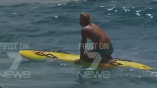 Camera-shy Gold Coast lifeguard Nick Malcolm has declined to comment on his high-profile rescue.